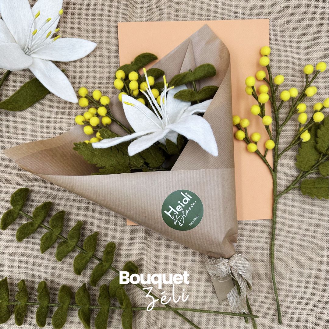Bouquet Zéli Lys mimosa New Heidi emballé dans du papier kraft recyclé prêt à offrir.