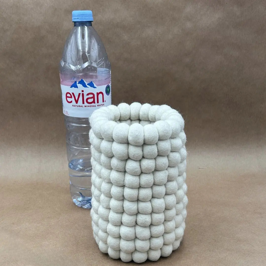 Comparaison de taille entre le vase en feutrine New Heidi et une bouteille d'eau de 1,5L pour l'étanchéité.