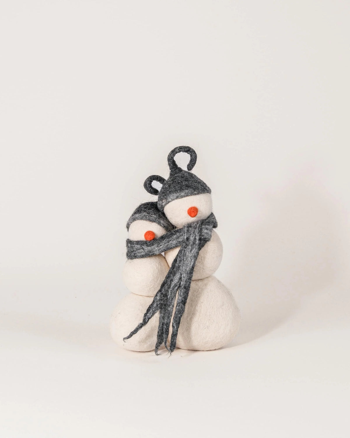 Bonhomme de neige double en feutrine sur un fond blanc.