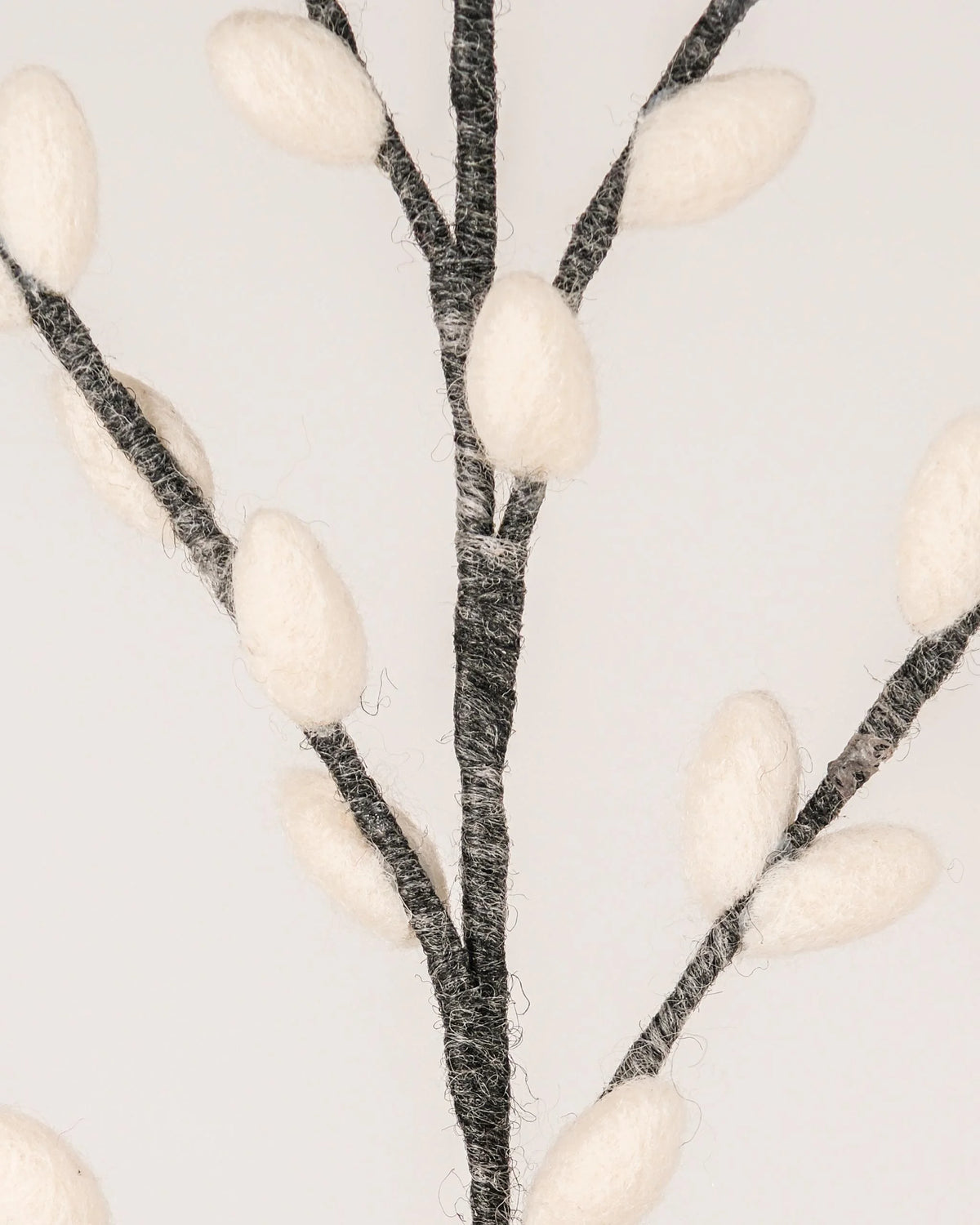  Photo zoom d'une branche de chaton de saule gris géante en feutrine sur un fond blanc style photo packshot.