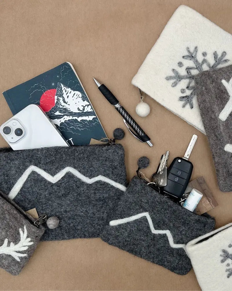 Pochette en laine feutrée utilisée comme organiseur de sac pour iPhone, clés et carnet.